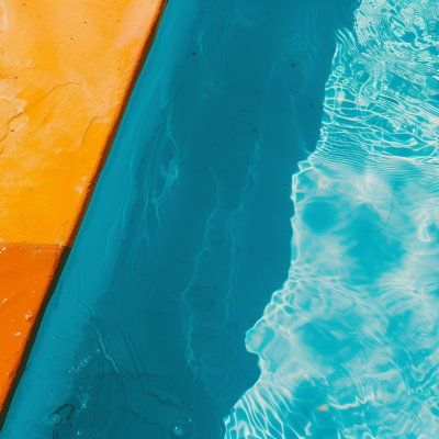 Aerial view of a clear blue ocean next to an orange and tan shoreline.